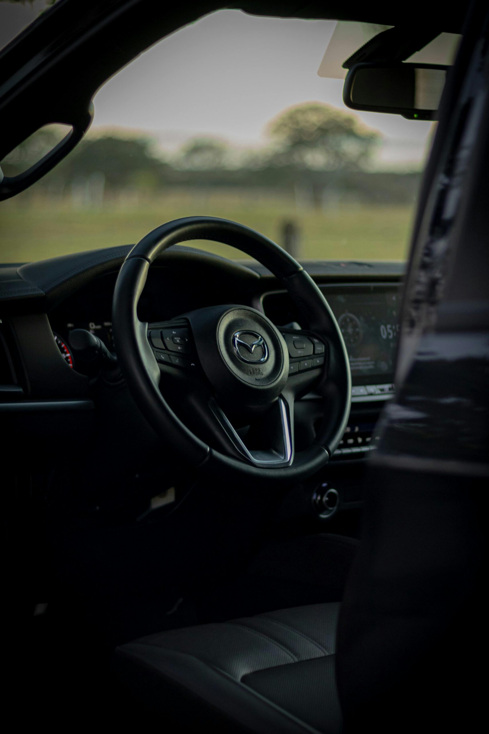 Home Close-up of car dashboard and steering wheel in natural light.